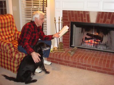 Grandpa sits down with his pup at his side